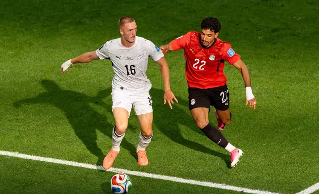Egypt's Omar Marmoush (22) challenges New Zealand's Finn Surman (16) during the first half of a World Cup Group G soccer match, n Vancouver, British Columbia, Sunday, June 21, 2026. (Tmothy Matwey/The Canadian Press via AP)