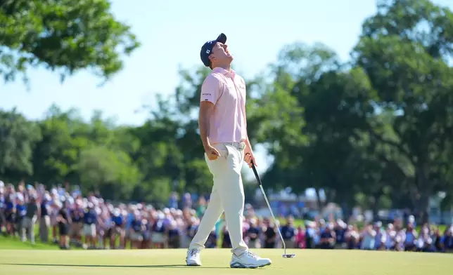 Russell Henley reacts after sinking a putt on the 18th hole during the final round of the Charles Schwab Challenge golf tournament at Colonial Country Club in Fort Worth, Texas, Sunday, May 31, 2026. (AP Photo/LM Otero)