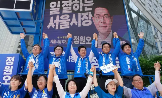 Seoul mayoral candidate Chong Won-o, top center, of the ruling Democratic Party raises his hands with his party members during an election campaign for June 3 nationwide simultaneous local elections in Seoul, South Korea, Tuesday, June 2, 2026. (AP Photo/Ahn Young-joon)