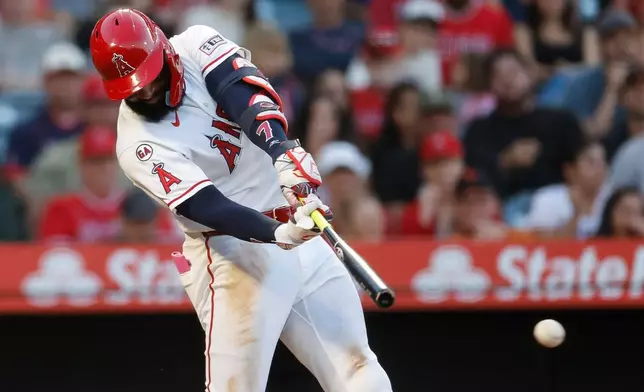 Los Angeles Angels' Jo Adell hits a two-run triple during the fourth inning of a baseball game against the Athletics, Saturday, June 27, 2026, in Anaheim, Calif. (AP Photo/Caroline Brehman)