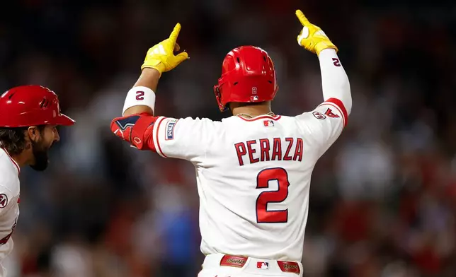 Los Angeles Angels' Oswald Peraza (2) reacts after hitting a one-run single during the eighth inning of a baseball game against the Athletics, Saturday, June 27, 2026, in Anaheim, Calif. (AP Photo/Caroline Brehman)