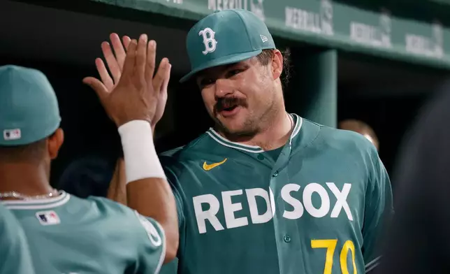 Boston Red Sox starting pitcher Payton Tolle (70) is congratulated by teammates in the dugout after the seventh inning of a baseball game against the New York Yankees, Friday, June 26, 2026, in Boston. (AP Photo/Mary Schwalm)