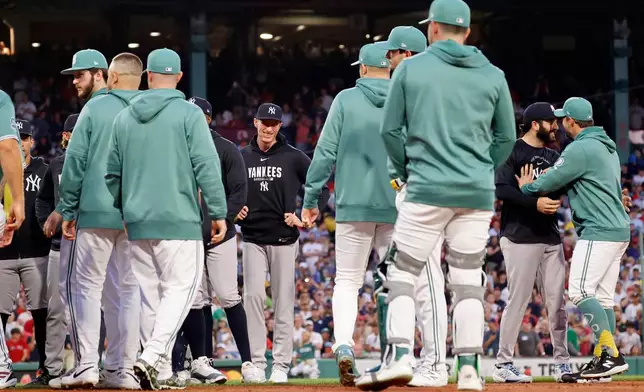 Boston Red Sox and New York Yankees players and coaches clear the benches during the fifth inning of a baseball game, Friday, June 26, 2026, in Boston. (AP Photo/Mary Schwalm)