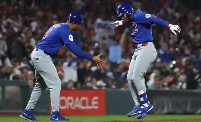Chicago Cubs' Pedro Ramírez, right, celebrates his solo home run with third base coach Quintin Berry, left, during the fifth inning of a baseball game against the San Francisco Giants Saturday, June 13, 2026, in San Francisco, Calif. (AP Photo/Scott Marshall)