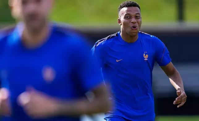 France's Kylian Mbappe smiles during a training session ahead of the team's World Cup Group I soccer match against Iraq in Philadelphia, Sunday, June 21, 2026. (AP Photo/Petr David Josek)