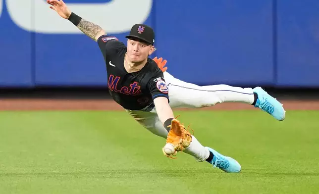 New York Mets' A.J. Ewing attempts to catch a ball hit by Philadelphia Phillies' J.T. Realmuto for a double during the fourth inning of a baseball game Friday, June 26, 2026, in New York. (AP Photo/Frank Franklin II)