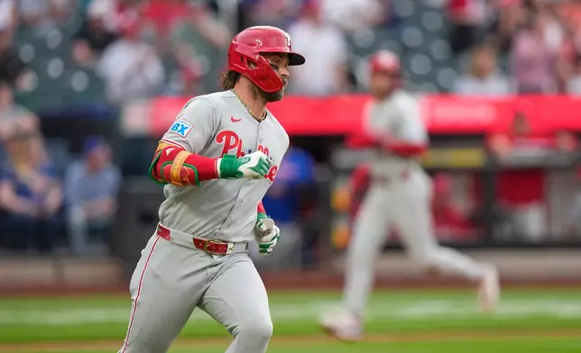 Philadelphia Phillies' Bryce Harper runs to first base for an RBI single during the first inning of a baseball game against the New York Mets Friday, June 26, 2026, in New York. (AP Photo/Frank Franklin II)