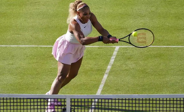 Serena Williams of the United States, hits a return as she and playing partner Victoria Mboko of Canada play against Nicole Melichar-Martinez of Canada and Erin Routliffe of New Zealand during their first round doubles match at the Queen's Club tennis championships in London, Tuesday, June 9, 2026. (AP Photo/Alberto Pezzali)