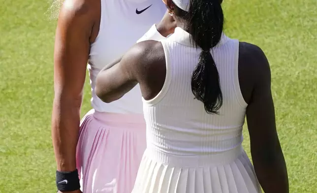 Serena Williams of the United States, left, talks to playing partner Victoria Mboko of Canada as they play against Nicole Melichar-Martinez of Canada and Erin Routliffe of New Zealand during their first round doubles match at the Queen's Club tennis championships in London, Tuesday, June 9, 2026. (AP Photo/Alberto Pezzali)
