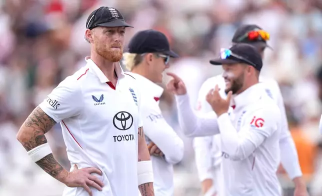 England's Ben Stokes, left looks on with teammates on day four of the Third Test cricket match between England and New Zealand, in Nottingham, England, Sunday June 28, 2026. (Joe Giddens/PA via AP)