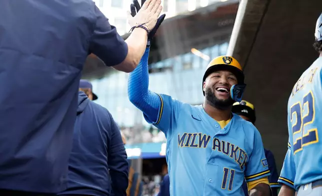Milwaukee Brewers' Jackson Chourio (11) is greeted by teammates after hitting a two run home run during the first inning of a baseball game against the Athletics, Tuesday, June 9, 2026, in Las Vegas. (AP Photo/Caroline Brehman)