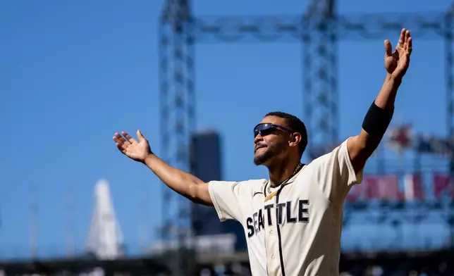 Seattle Mariners' Julio Rodriguez celebrates after a baseball game against the Arizona Diamondbacks, Sunday, May 31, 2026, in Seattle. (AP Photo/Stephen Brashear)