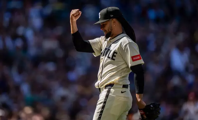 Seattle Mariners relief pitcher Luis Castillo pumps his fist while walking off the field during the 10th inning of a baseball game against the Arizona Diamondbacks, Sunday, May 31, 2026, in Seattle. (AP Photo/Stephen Brashear)