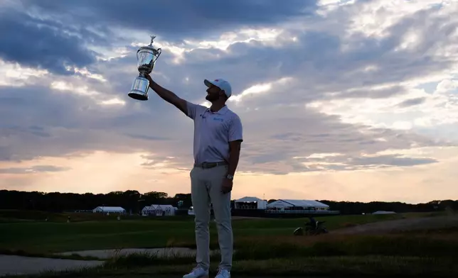 Wyndham Clark holds the trophy after winning the U.S. Open golf tournament at Shinnecock Hills Golf Club in Southampton, N.Y., Sunday, June 21, 2026. (AP Photo/Seth Wenig)