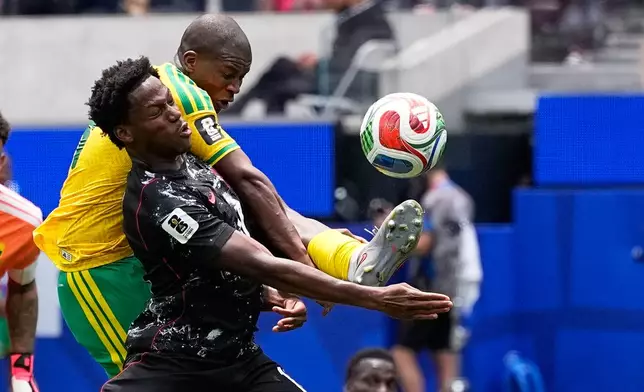 Canada's Jonathan David, front, and South Africa's Mbekezeli Mbokazi battle for the ball Jonathan David, Mbekezeli Mbokazi during the World Cup round of 32 soccer match in Inglewood, Calif., near Los Angeles, Sunday, June 28, 2026. (AP Photo/Gregory Bull)