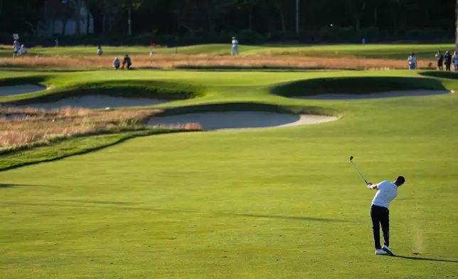 Wyndham Clark hits from the fairway on the 15th hole during the third round of the U.S. Open golf tournament at Shinnecock Hills Golf Club in Southampton, N.Y., Saturday, June 20, 2026.(AP Photo/George Walker IV)