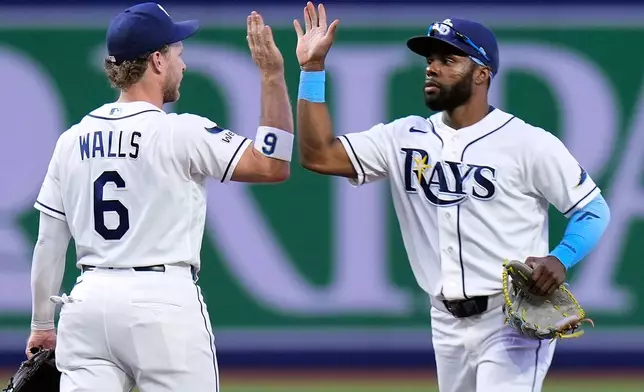 Tampa Bay Rays shortstop Taylor Walls (6) and center fielder Cedric Mullins celebrate after the team defeated the Boston Red Sox during a baseball game Tuesday, June 9, 2026, in St. Petersburg, Fla. (AP Photo/Chris O'Meara)