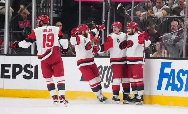 Carolina Hurricanes right wing Jackson Blake, second from right, celebrates his goal with teammates during the second period in Game 6 of the NHL hockey Stanley Cup Final series against the Vegas Golden Knights, Sunday, June 14, 2026, in Las Vegas. (AP Photo/John Locher)