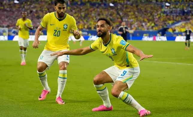 Brazil's Matheus Cunha (9) celebrates with Lucas Paqueta (20) after scoring their third goal during the World Cup Group C soccer match between Scotland and Brazil in Miami Gardens, Fla., Wednesday, June 24, 2026. (AP Photo/Lynne Sladky)