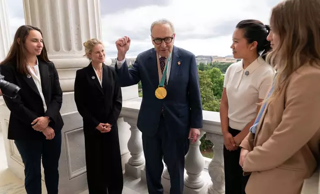 Senate Minority Leader Chuck Schumer, D-N.Y., speaks with Olympians Julia Kern, from left, Jessie Diggins, Bea Kim and Olivia Giaccio, during a meeting to advocate for clean air, clean water and a healthy planet on Capitol Hill, Tuesday, June 23, 2026, in Washington. (AP Photo/Jose Luis Magana)