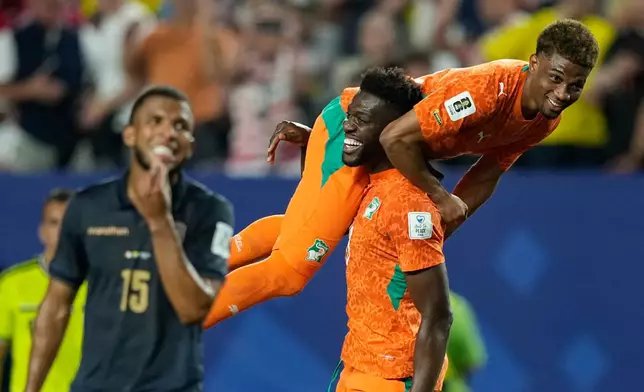 Ivory Coast's Ibrahim Sangare carries teammate Amad Diallo after defeating Ecuador in a World Cup Group E soccer match in Philadelphia, Sunday, June 14, 2026. (AP Photo/Matt Slocum)