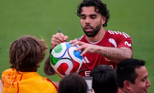 Spain goalkeeper David Raya gives autographs to fans after a training session, Saturday, June 6, 2026, in Chattanooga, Tenn., ahead of the World Cup soccer tournament. (AP Photo/Mike Stewart)