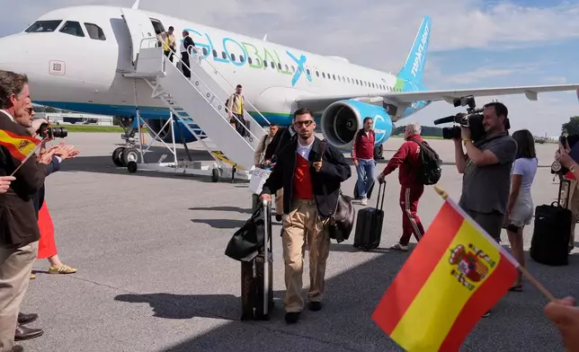 Spain forward Alex Baena walks across the tarmac after arriving with teammates for the World Cup soccer tournament Friday, June 5, 2026, in Chattanooga, Tenn. (AP Photo/George Walker IV)