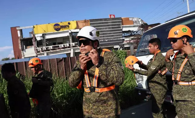 Rescuers prepare for a search operation following an earthquake in General Santos, Philippines Tuesday, June 9, 2026. (AP Photo/Basilio Sepe)