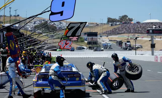 The pit crew for Chase Elliott works on the car during a NASCAR Cup Series auto race at Sonoma Raceway, Sunday, June 28, 2026, in Sonoma, Calif. (AP Photo/Jeff Chiu)