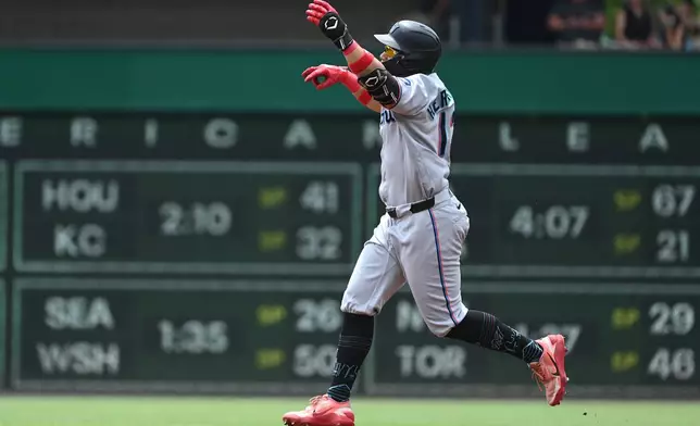 Miami Marlins left fielder Heriberto Hernandez (13) celebrates a solo home run hit off of Pittsburgh Pirates starting pitcher Paul Skenes during the second inning of a baseball game, Sunday, June 14, 2026, in Pittsburgh. (AP Photo/Philip G. Pavely)