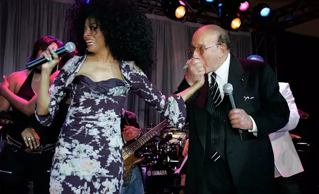 FILE - Clive Davis kisses the hand of Diana Ross at his annual pre- grammy party at the Beverly Hills Hotel in Beverly Hills, Calif. on Saturday Feb. 12, 2005. (AP Photo/Chris Polk)