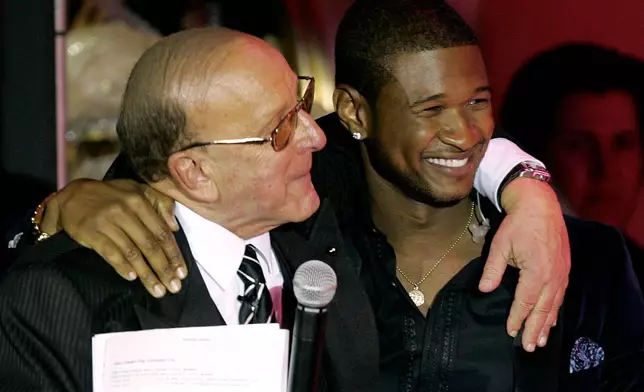 FILE - Clive Davis, left, and Usher appear at Davis' 2005 pre Grammy party in Beverly Hills, Calif. on Feb. 12, 2005. (AP Photo/Chris Polk, File)