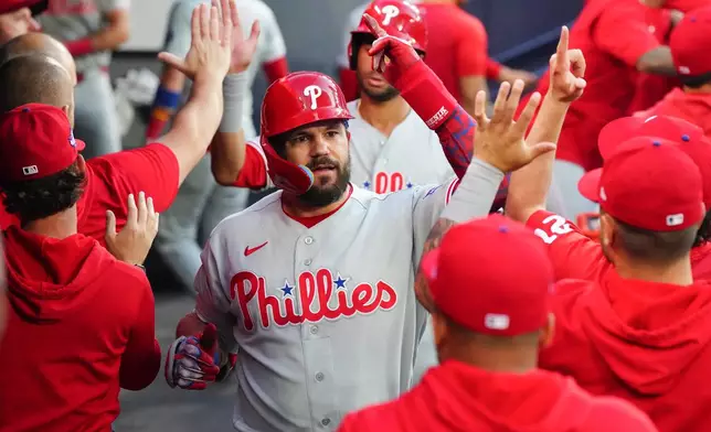 Philadelphia Phillies' Kyle Schwarber celebrates in the dugout after hitting a two-run home run off Toronto Blue Jays pitcher Mason Fluharty during the fourth inning of a baseball game in Toronto on Wednesday June 10, 2026. (Chris Young/The Canadian Press via AP)