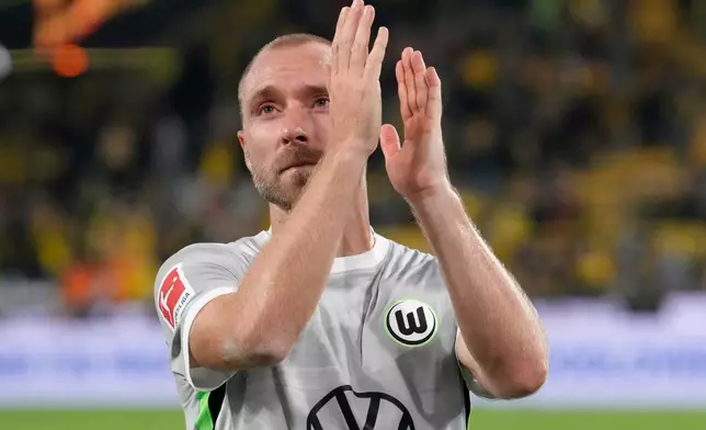 FILE - Wolfsburg's Christian Eriksen applauds to supporters at the end of the German Bundesliga soccer match between Borussia Dortmund and VfL Wolfsburg in Dortmund, Germany, Sept. 21, 2025. (AP Photo/Martin Meissner, File)