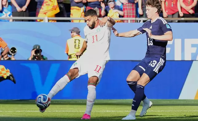 Morocco's Ismael Saibari, left, scores his side's opening goal pst Scotland's Jack Hendry during the World Cup Group C soccer match between Scotland and Morocco in Foxborough, Mass., near Boston, Friday, June 19, 2026. (AP Photo/Martin Meissner)