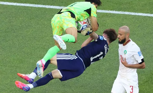 Morocco goalkeeper Yassine Bounou (1) collides with Scotland's Ben Gannon-Doak (17) during the World Cup Group C soccer match between Scotland and Morocco in Foxborough, Mass., near Boston, Friday, June 19, 2026. (AP Photo/Mark Stockwell)