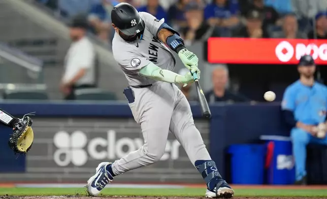 New York Yankees' Ali Sánchez hits a RBI double off Toronto Blue Jays pitcher Patrick Corbin during the second inning of a baseball game in Toronto on Sunday June 14, 2026. (Chris Young/The Canadian Press via AP)