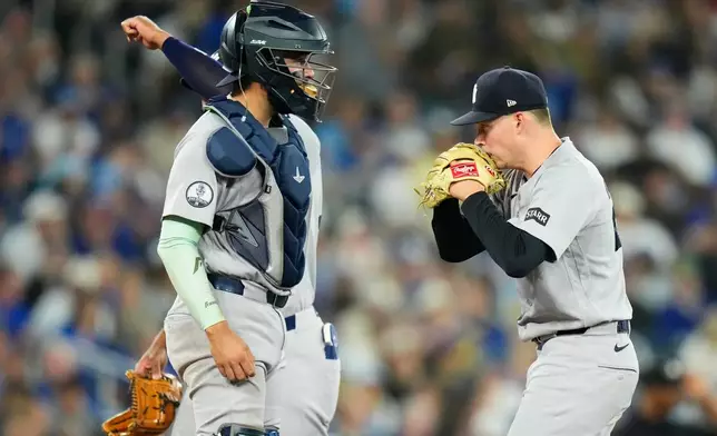 New York Yankees pitcher Will Warren (29) receives a mound visit from catcher Ali Sánchez (39) after loading the bases during the second inning of a baseball game against the Toronto Blue Jays in Toronto on Sunday June 14, 2026. (Chris Young/The Canadian Press via AP)