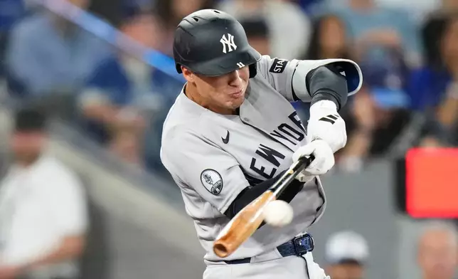 New York Yankees' Anthony Volpe hits an RBI single off Toronto Blue Jays pitcher Patrick Corbin during the second inning of a baseball game in Toronto on Sunday June 14, 2026. (Chris Young/The Canadian Press via AP)