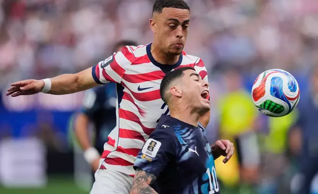 Paraguay's Miguel Almiron, right, and United States' Sergino Dest battle for the ball during the World Cup Group D soccer match between the United States and Paraguay in Inglewood, Calif., near Los Angeles, Friday, June 12, 2026. (AP Photo/Mark J. Terrill)
