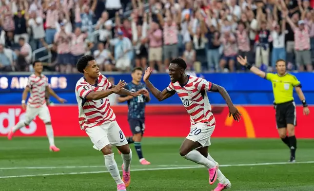 United States' Folarin Balogun (20) celebrates scoring his side's second goal against Paraguay during the World Cup Group D soccer match in Inglewood, Calif., near Los Angeles, Friday, June 12, 2026. (AP Photo/Andre Penner)