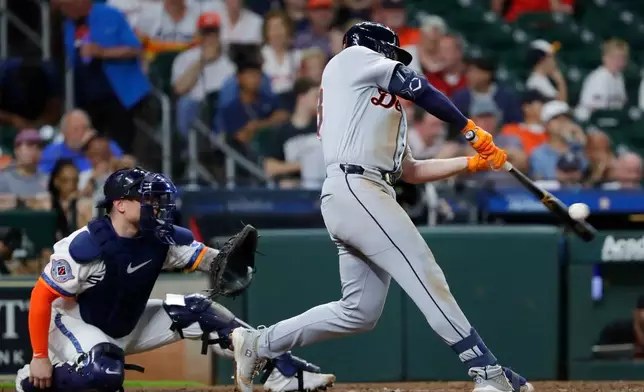 Detroit Tiger' Colt Keith, right, connects for a two-run home run in front of Houston Astros catcher Christian Vazquez, left, during the third inning of a baseball game Monday, June 15, 2026, in Houston. (AP Photo/Michael Wyke)