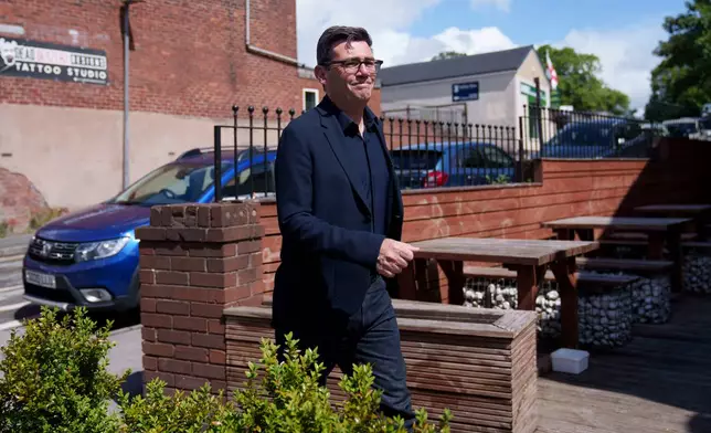 Andy Burnham walks during a campaign visit to the town of Ashton-in-Makerfield before the forthcoming Makerfield by-election, in Greater Manchester, England, Tuesday, June 9, 2026. (AP Photo/Jon Super)