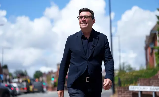 Andy Burnham smiles during a campaign visit to Ashton-in-Makerfield before the forthcoming by-election, in Manchester, England, Tuesday, June 9, 2026. CORRECTION: corrects family name to Burnham instead of Bunham (AP Photo/Jon Super)