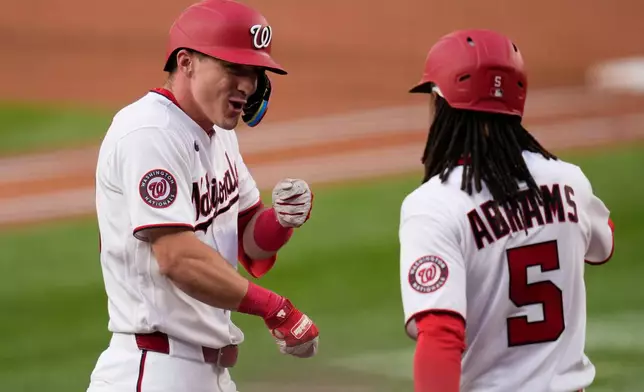 Washington Nationals' Jacob Young, left, celebrates after his home run against the Miami Marlins with CJ Abrams (5) during the second inning of a baseball game, Monday, June 1, 2026, in Washington. (AP Photo/Jess Rapfogel)