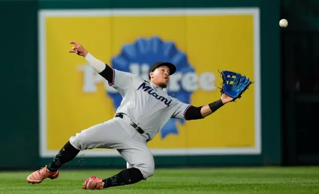 Miami Marlins left fielder Heriberto Hernández catches a ball hit by Washington Nationals' Luis García Jr. during the sixth inning of a baseball game, Monday, June 1, 2026, in Washington. (AP Photo/Jess Rapfogel)