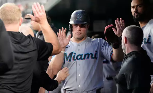 Miami Marlins' Jakob Marsee celebrates with teammates in the dugout after scoring against the Washington Nationals on a hit by Connor Norby during the sixth inning of a baseball game, Monday, June 1, 2026, in Washington. (AP Photo/Jess Rapfogel)