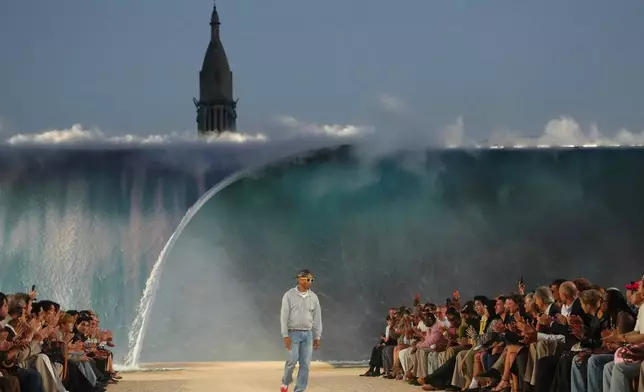 Designer Pharrell Williams accepts applause afte the Louis Vuitton men's Spring Summer 2027 collection presented in Paris, France, Tuesday, June 23, 2026. (AP Photo/Aurelien Morissard)
