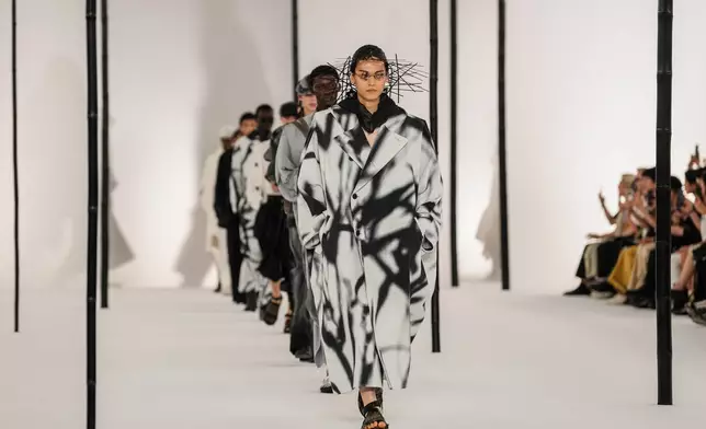 Models wear creations as part of the Issey Miyake Homme Spring Summer 2027 collection presented in Paris, France, Thursday, June 25, 2026. (AP Photo/Aurelien Morissard)