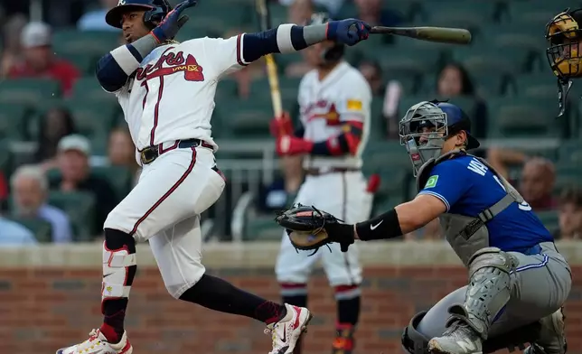 Atlanta Braves' Ozzie Albies (1) hits a double in the third inning of a baseball game against the Toronto Blue Jays, Wednesday, June 3, 2026, in Atlanta. (AP Photo/Mike Stewart)